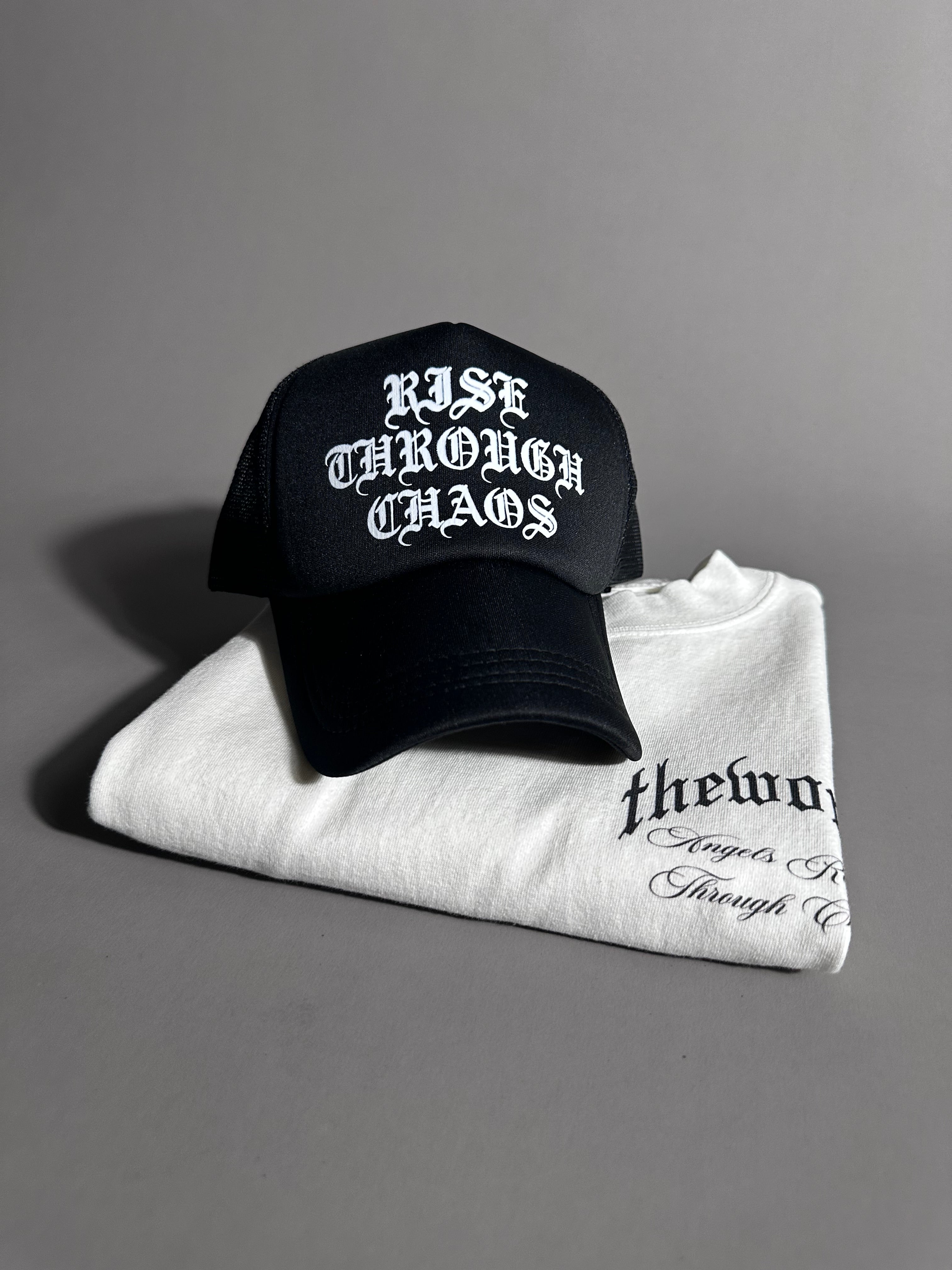 RISE THROUGH CHAOS TRUCKER HAT IN BLACK