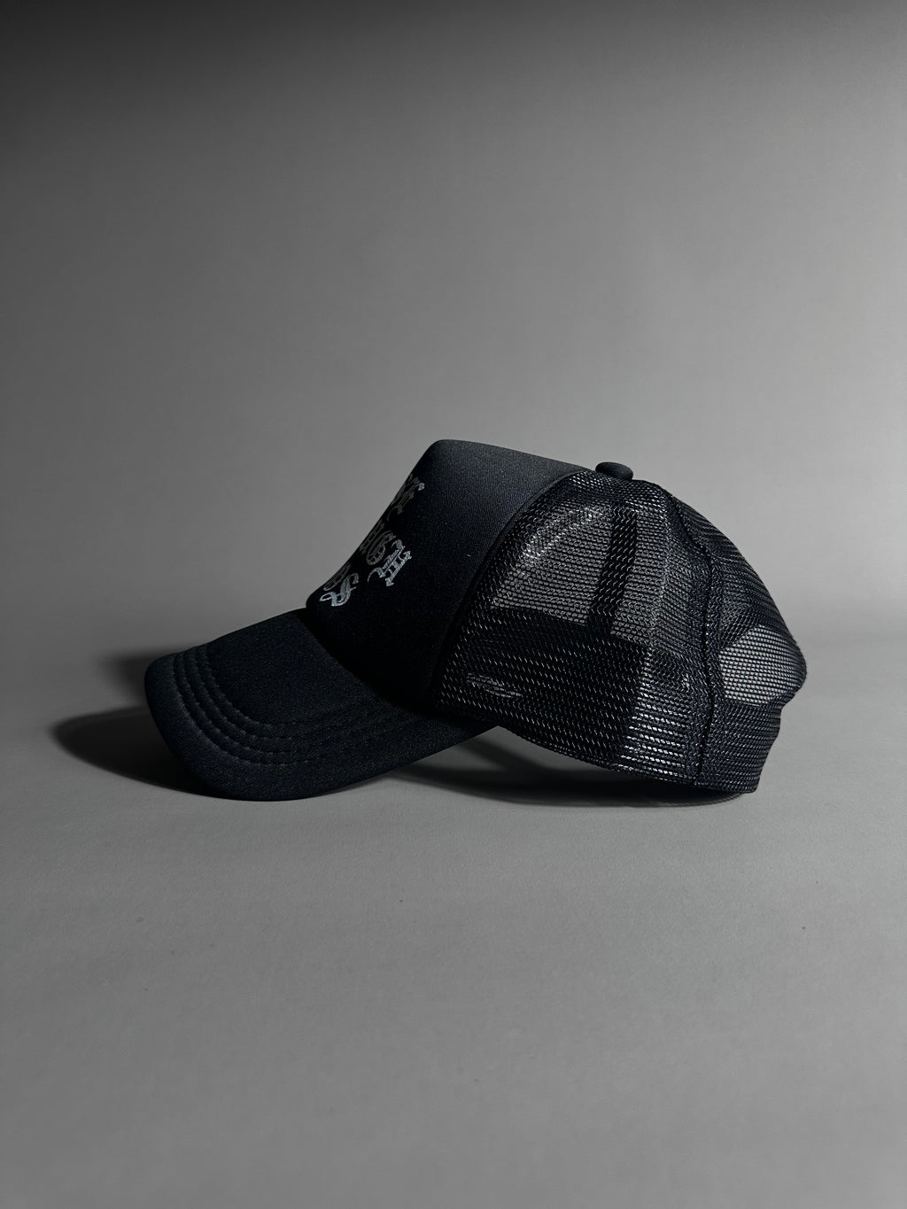 RISE THROUGH CHAOS TRUCKER HAT IN BLACK