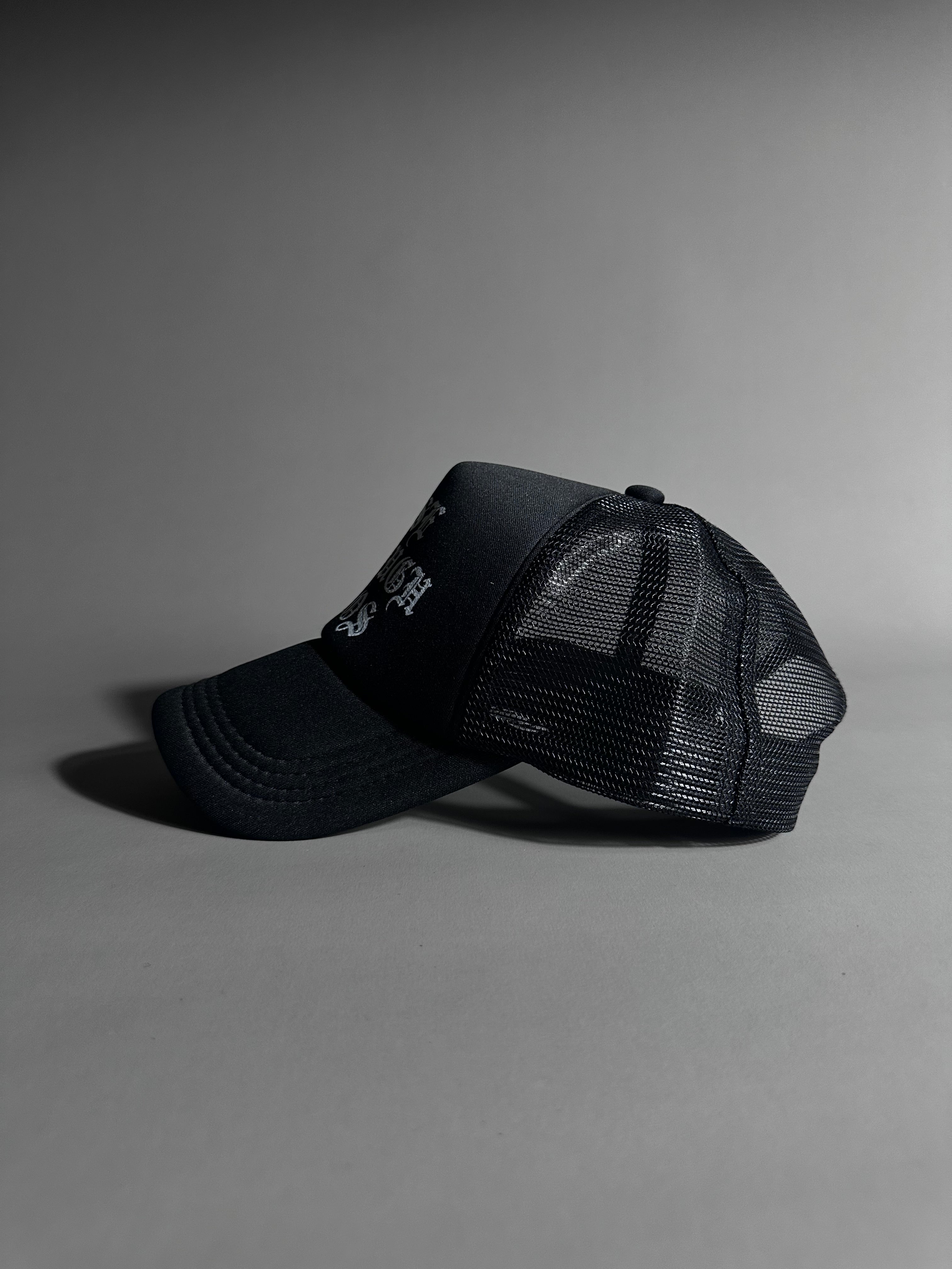 RISE THROUGH CHAOS TRUCKER HAT IN BLACK