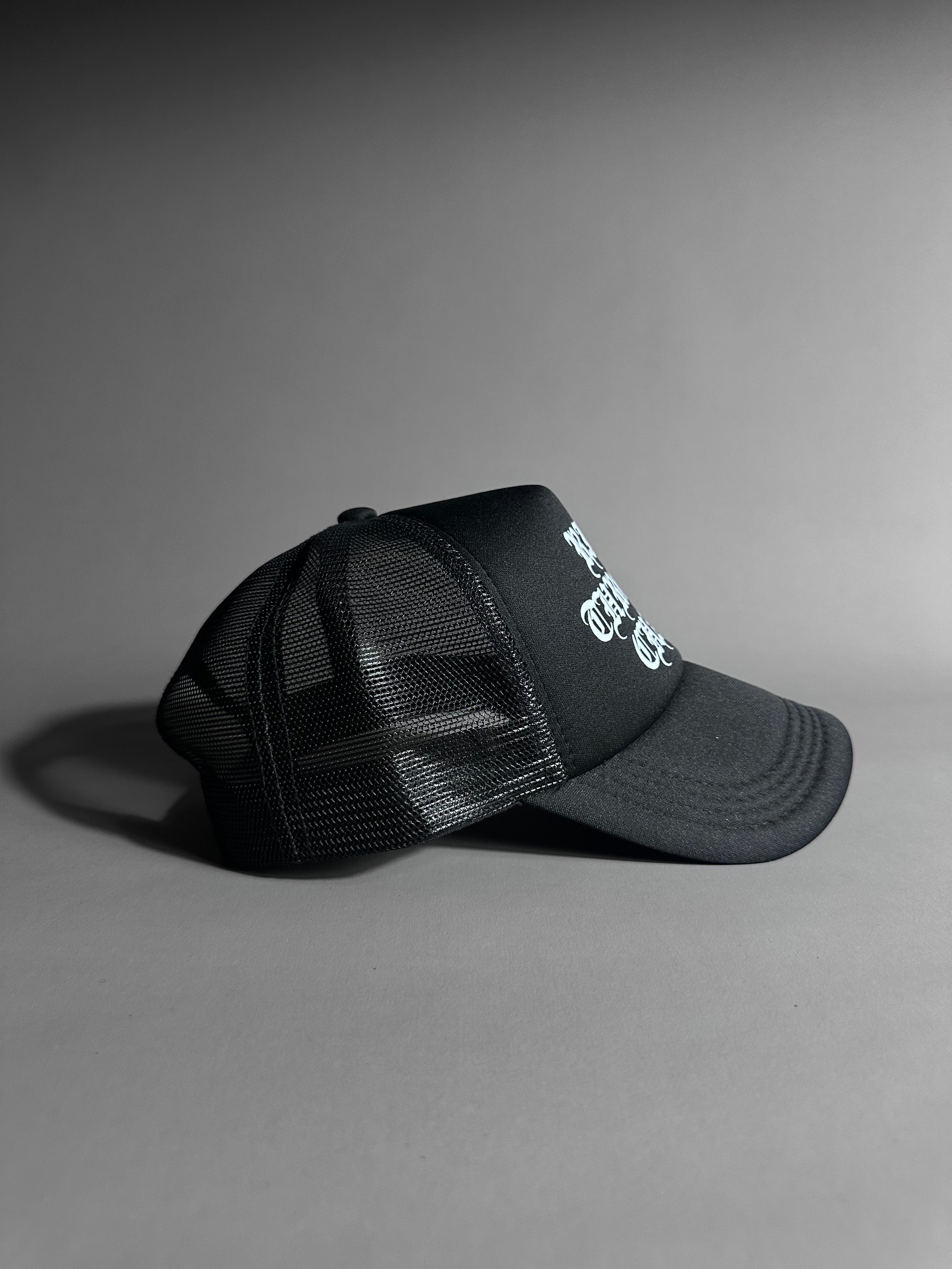 RISE THROUGH CHAOS TRUCKER HAT IN BLACK